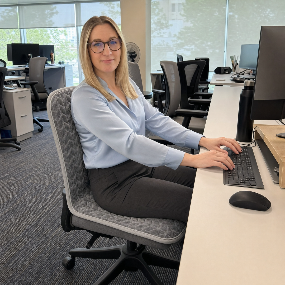Woman working warm at her desk on ChairHug
